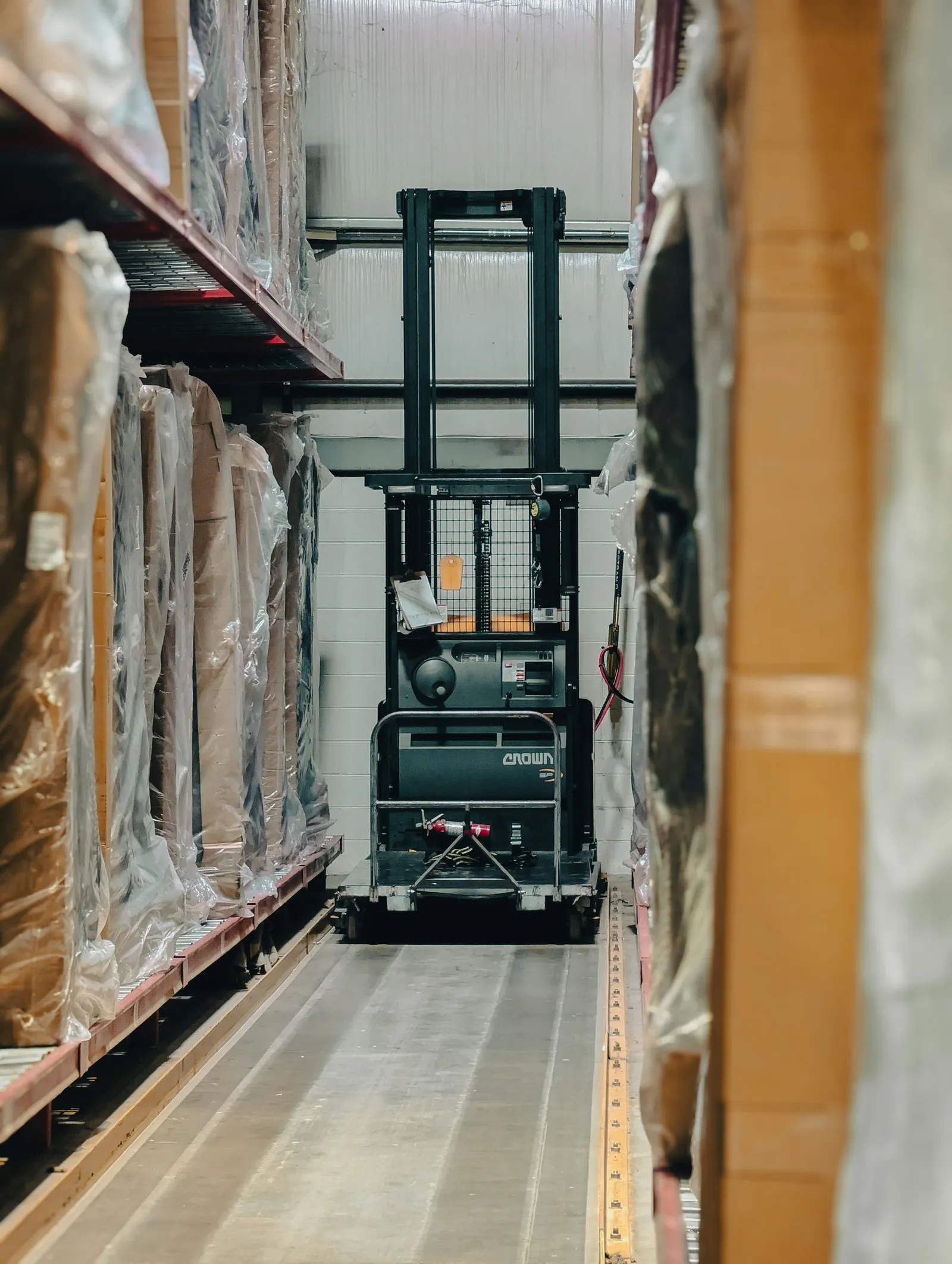 Forklift operating among stored packaging materials